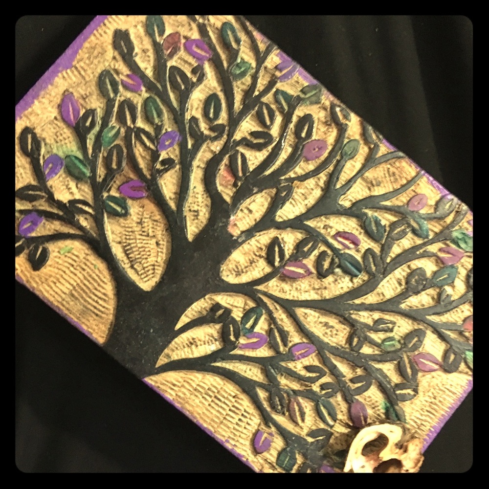 Wooden box with a tree on it, has some color.